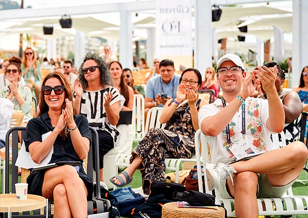 People in deck chairs watching a live event